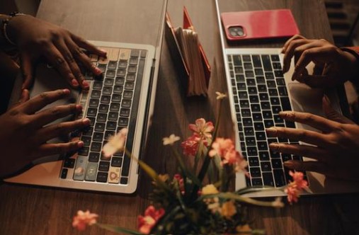 A smiling person in a professional setting with abstract lights