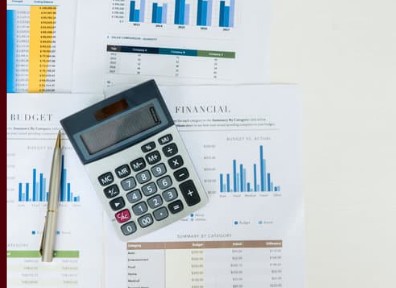 A smiling person in a professional setting with abstract lights